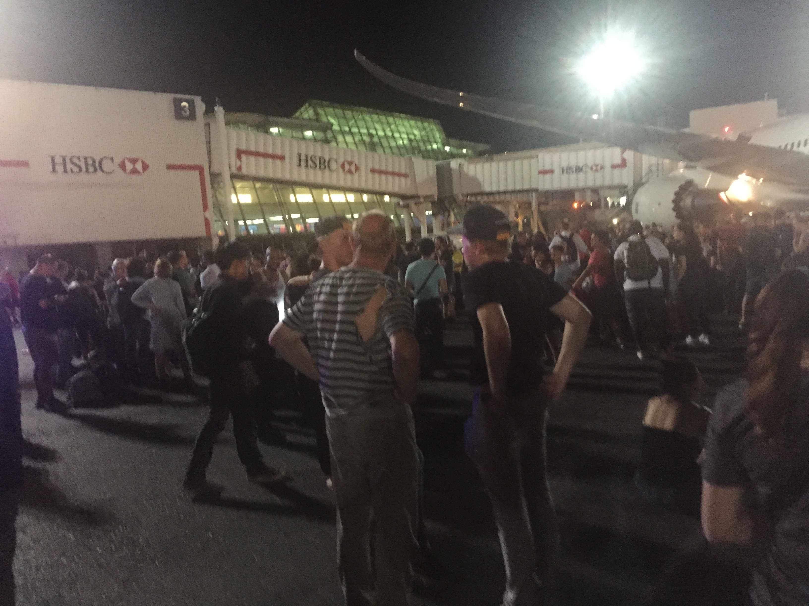 Crowd including man with torn shirt